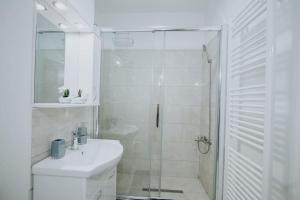 a bathroom with a shower and a toilet and a sink at Plaza View in Bucharest +5 photos