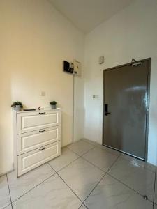 a room with a dresser and a sliding door at SW Rental in Penampang