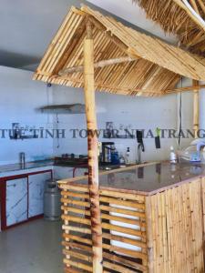 a kitchen with a wooden counter top in a room at Tuệ Tĩnh Tower in Nha Trang
