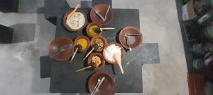 a group of bowls and spoons on a table at Sura Homestay Kandy in Kandy