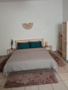 a bedroom with a large bed with blue pillows at Studio 'Katerina by the Sea' in Salamina