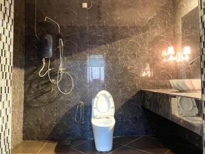 a bathroom with a toilet and a sink at Family's Homestay in Kuala Terengganu