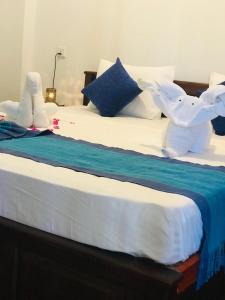 Postel nebo postele na pokoji v ubytování Tamaro Beach Resort