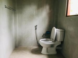a bathroom with a toilet and a shower at Meyola Guest house in Weligama