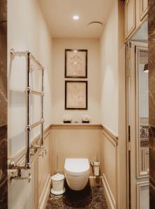 a bathroom with a toilet and a sink at Cobergher Hotel in Kortrijk