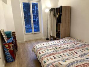 Ένα ή περισσότερα κρεβάτια σε δωμάτιο στο Superbe appartement proche Paris
