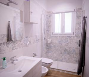 a bathroom with a toilet and a sink and a shower at Da Nonna Maria in Grottaglie +32 photos