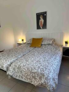 a bedroom with a bed with a blue and white comforter at Pachi Beach Atlantic Garden Corralejo in Corralejo