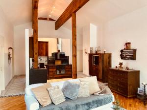 a living room with a couch and a dresser at Landhaus Frank in Bad Kleinkirchheim