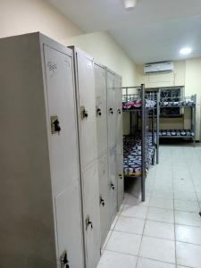 a row of lockers in a room with shoes at Boon Boys Bed Space Near Dubai Airport in Dubai