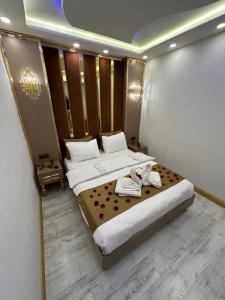 a bedroom with a large bed with towels on it at Moonlight Suit Hotel Taksim in Istanbul