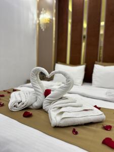 two towels in the shape of a heart on a bed at Moonlight Suit Hotel Taksim in Istanbul