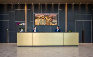 a man and woman standing at a reception desk at Luxury Pentstudio Westlake - Tay Ho, Ha Noi in Hanoi +50 photos