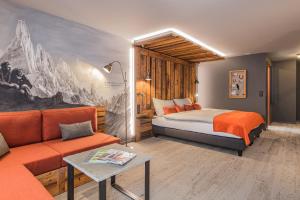 a hotel room with a bed and a couch at BaseCamp Hotel in Zermatt +60 photos