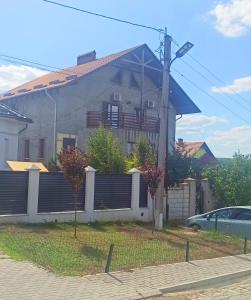 una casa con una valla delante de ella en Квартира на земле, en Chişinău