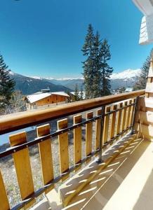 a balcony of a house with a view of the mountains at Le 1954 La Rosière in Montvalezan