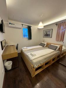 a bedroom with a large bed and a desk at Savka Splav in Belgrade