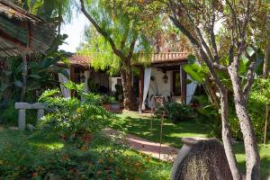 a house with a garden in front of it at Nora Club Hotel & Spa in Pula