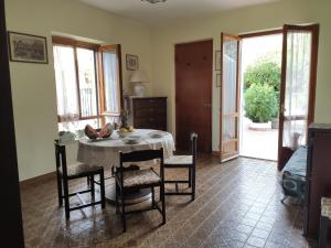 a dining room with a table and chairs in a room at Casa Degli Oleandri Sul Cortile R6314 in Cala Gonone