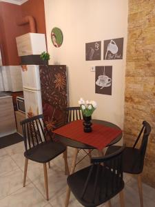 a dining room with a table and chairs with flowers on it at home2024 in Alexandroupoli