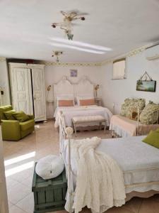 a large room with two beds and a couch at Ca' Datu in Finale Ligure