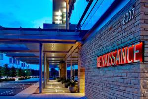 a building with a sign on the side of it at Renaissance Dallas at Plano Legacy West Hotel in Plano