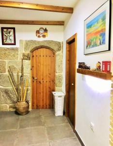 a hallway with a wooden door in a room at Casa Turistica Nigrán in Nigrán