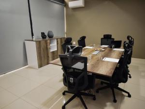 a conference room with a wooden table and chairs at The Anza Lifestyle Lodge in Louis Trichardt