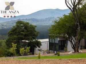 a view of a building with mountains in the background at The Anza Lifestyle Lodge in Louis Trichardt