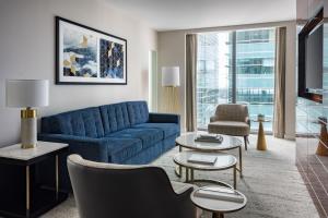 a living room with a blue couch and tables at JW Marriott Marquis Miami in Miami