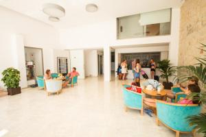 a group of people sitting in chairs in a room at Hotel Amic Gala in Can Pastilla