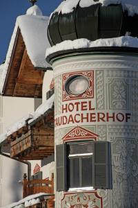 a building with snow on the top of it at Hotel Staudacherhof History & Lifestyle in Garmisch-Partenkirchen