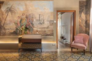 ein Wohnzimmer mit einem Wandgemälde in der Unterkunft Piazza Pitti Palace - Residenza d'Epoca in Florenz
