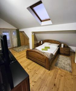 a bedroom with a bed and a skylight at Grand Central House in Odorheiu Secuiesc