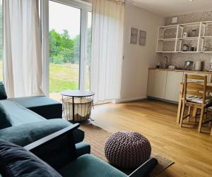 a living room with a couch and a table at Osada Hygge in Gostynin