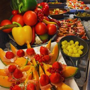 a buffet filled with fruits and vegetables on a table at Altes Pfarrhaus 