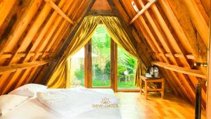 sypialnia z łóżkiem w drewnianym namiocie w obiekcie New DGYP Ciater Resort w mieście Ciater