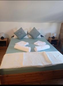 a bed with blue and white pillows on it at Apartment Kirili and Metodi 41 - 8 С in Berkovitsa
