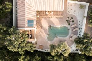 an overhead view of a swimming pool next to a house at Nono's Fioro Premium Houses, By TK Property Management in Gaïtánion