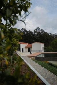 a building with a pool in front of it at Casa da Milheira - Agroturismo in Oliveira de Azemeis