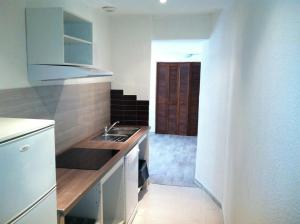 a kitchen with a sink and a counter top at Apart'Hôtel Les 4 Sources in Anduze