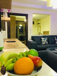 a bowl of fruit on a table in a living room at Royal Luxury Amman Central Apartmetns in Amman