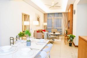 a dining room and living room with a table and chairs at 9 PAX, 2BR Balcony, 3mins to KLCC - 3A03 in Kuala Lumpur