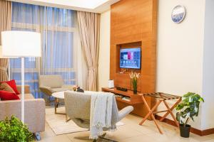 a living room with a table and a tv at 9 PAX, 2BR Balcony, 3mins to KLCC - 3A03 in Kuala Lumpur