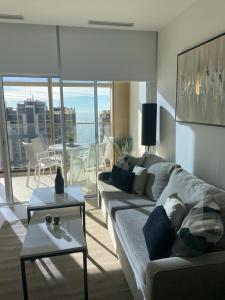 a living room with a couch and a table at sky intempo resort & spa Benidorm apartment in Benidorm