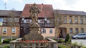 a statue of a man on a horse in front of a building at Haus Betty in Rattelsdorf
