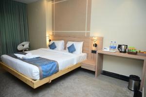 a bedroom with a large bed in a room at Pipul Ocean View Resort in Puri
