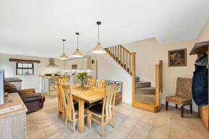 a kitchen and dining room with a table and chairs at Host & Stay - The Barn - Upper Farm in Tideswell +10 photos