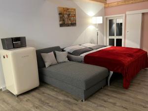 a small bedroom with a bed and a couch at Ferienwohnung Schwein gehabt in Allna