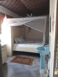 a bed with a canopy in a room at Baba Lao Hotel in Malindi